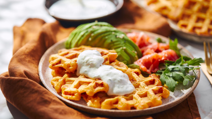 2WJ57DA Hearty sweet potato or pumpkin waffles with avocado, salmon, arugula and sauce